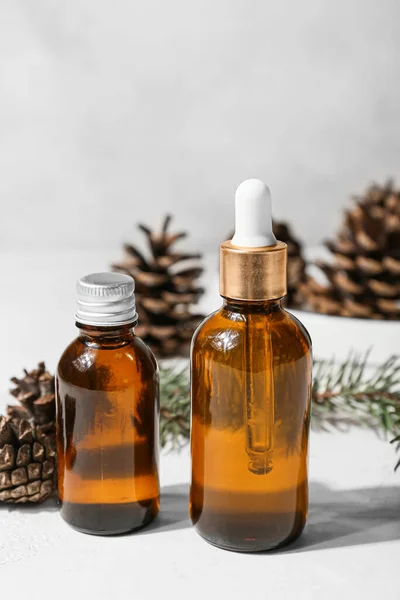 Bottles Essential Oil Pine Cones Light Background Closeup — Stock Photo, Image