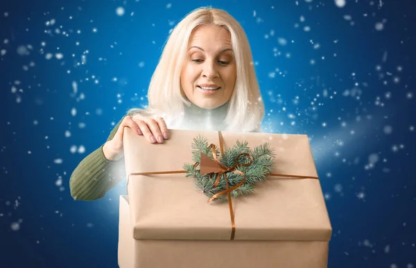 Mature Woman Opening Christmas Gift Color Background — Stock Photo, Image