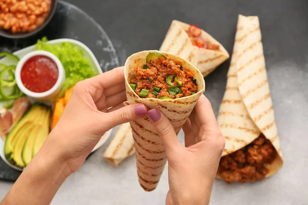 Woman Holding Tasty Burrito Grey Background — Stock Photo, Image