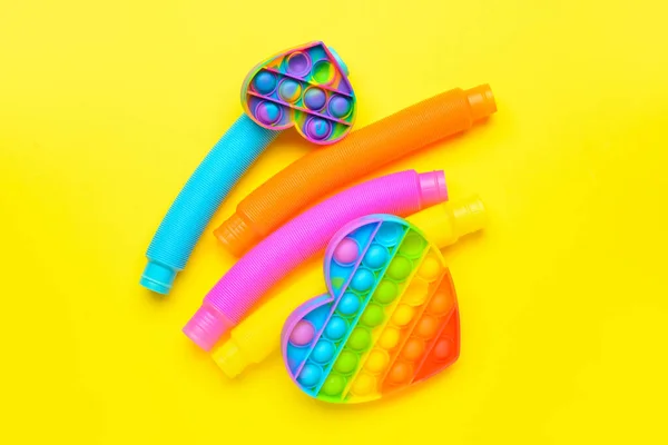 Colorful Pop Tubes Pop Fidget Toys Yellow Background — Stockfoto