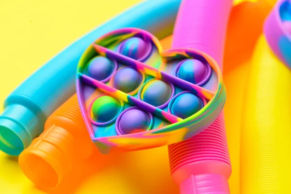 Colorido Pop Tubes Pop Fidget Brinquedo Fundo Amarelo — Fotografia de Stock