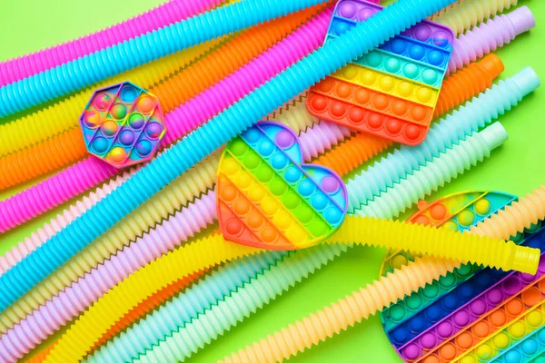 Colorful Pop Tubes Pop Fidget Toys Green Background — Stock Photo, Image