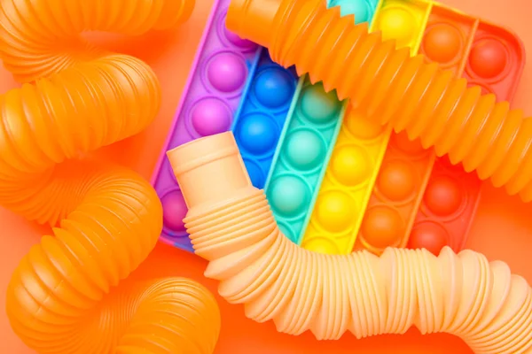Colorful Pop Tubes Pop Fidget Toy Orange Background — Stock Photo, Image