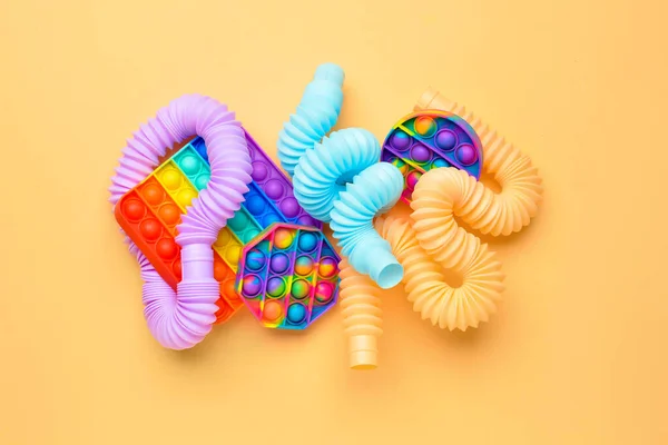 Colorful Pop Tubes Pop Fidget Toys Beige Background — Stock Photo, Image