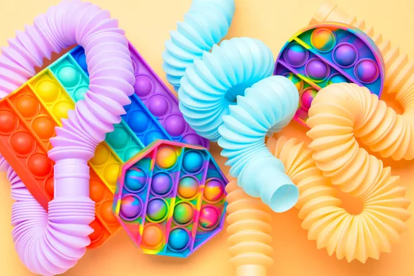 Colorful Pop Tubes Pop Fidget Toys Beige Background — Stock Photo, Image