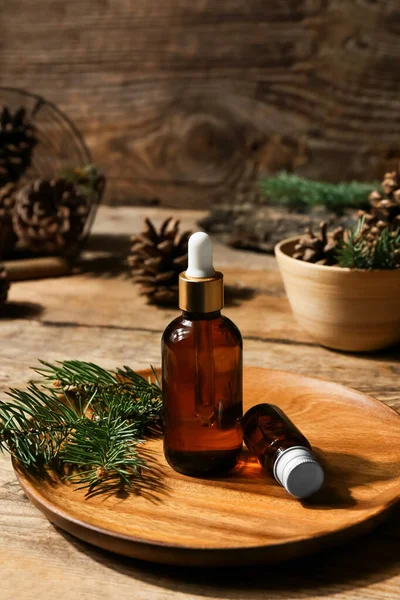 Plate Bottles Essential Oil Fir Branch Wooden Background — Stock Photo, Image