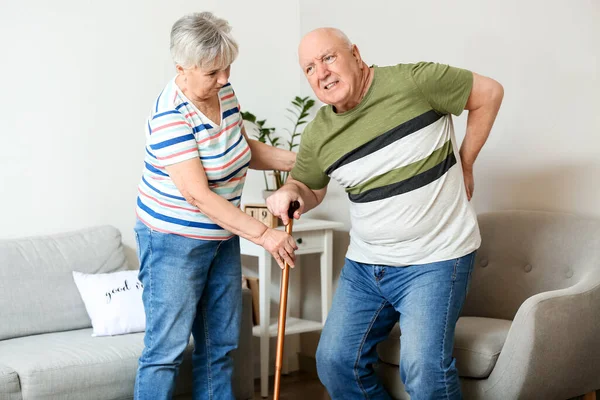 Senior Woman Helping Her Husband Back Pain Home — 스톡 사진