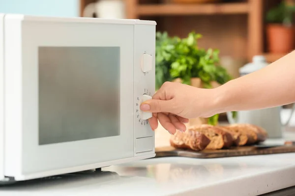 Housewife Adjusting Modern Microwave Oven Kitchen Closeup — стоковое фото