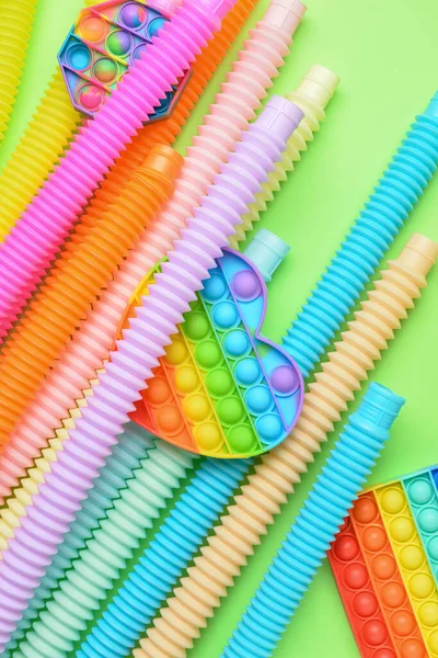 Colorful Pop Tubes Pop Fidget Toys Green Background — Stock Photo, Image