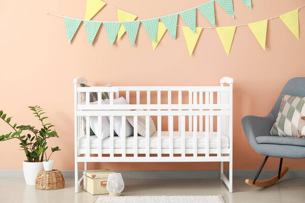 Interior of stylish children room with comfortable white crib