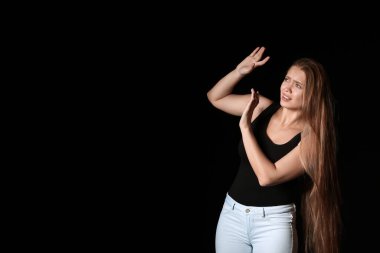 Karanlık arka planda korkmuş bir kadın. Şiddet kavramı