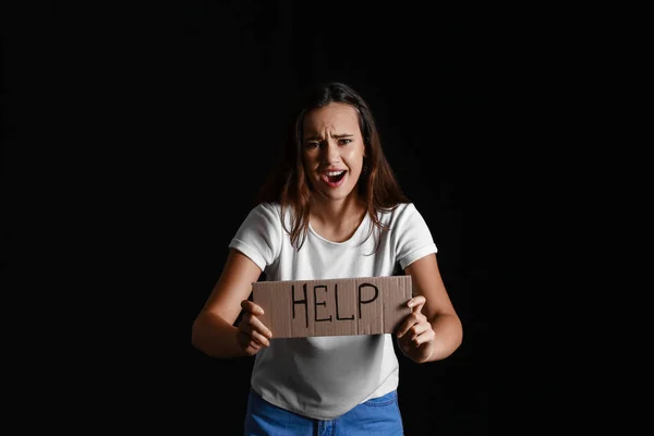 Scared Young Woman Holding Paper Word Help Black Background Violence — Stock Photo, Image