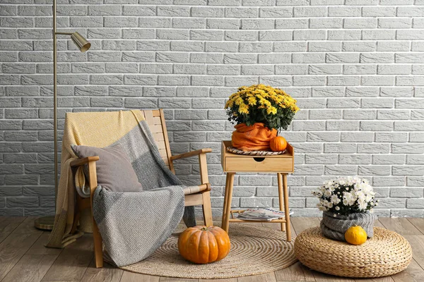 Interior Room Comfortable Armchair Chrysanthemum Flowers Grey Brick Wall — стоковое фото