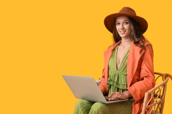 Portrait Young Fashionable Woman Sitting Chair Laptop Yellow Background — Stock Photo, Image