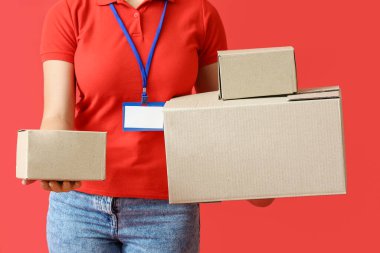 Renk arkaplanındaki paketlere sahip kadın kurye