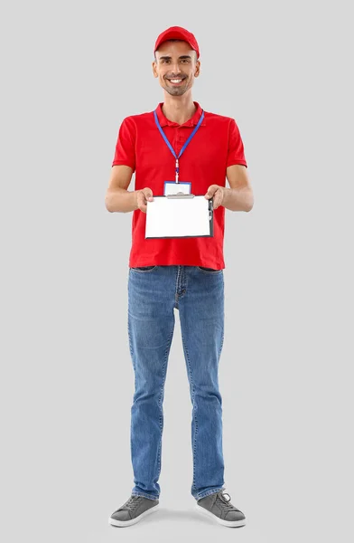 Male Courier Clipboard Light Background — Stock Photo, Image