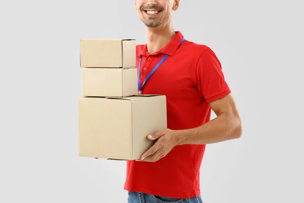 Male Courier Parcels Light Background — Fotografia de Stock