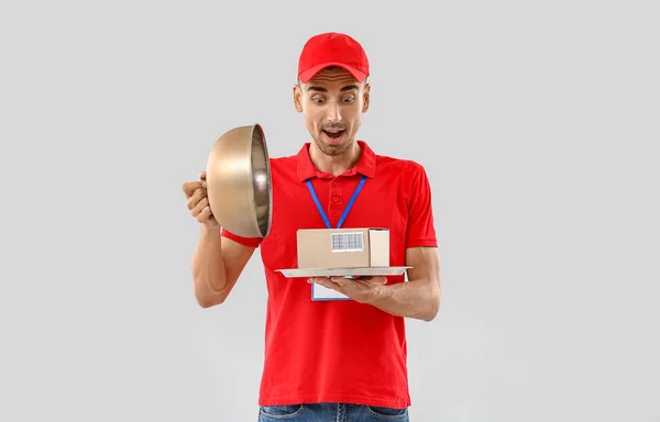 Surprised Male Courier Parcel Tray Light Background — Fotografia de Stock