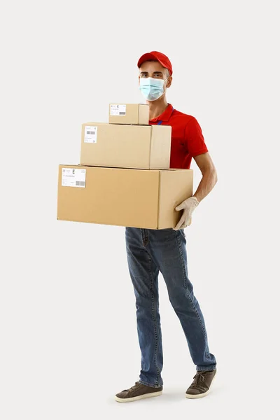 Male Courier Medical Mask Parcels Light Background — Stock Photo, Image