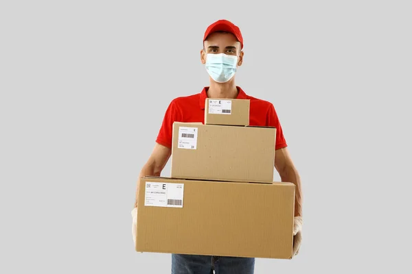 Male Courier Medical Mask Parcels Light Background — Stock Photo, Image