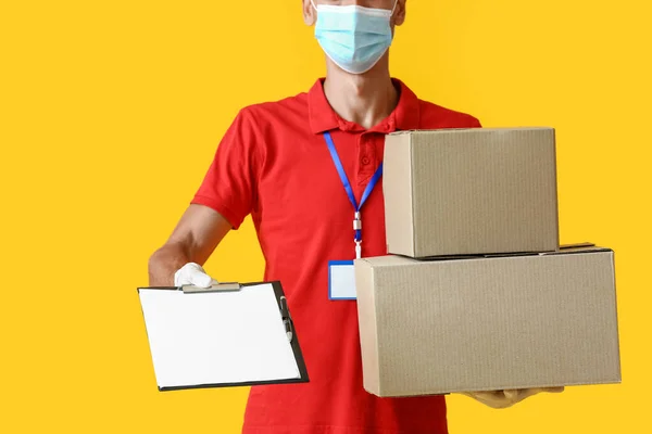 Male Courier Medical Mask Parcels Clipboard Color Background — Stock Photo, Image