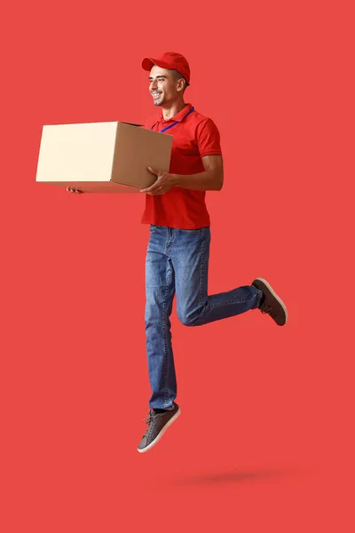 Jumping Male Courier Parcel Color Background — Fotografia de Stock