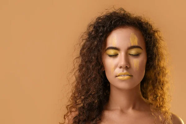 Beautiful Young Woman Yellow Paint Her Face Color Background — стоковое фото