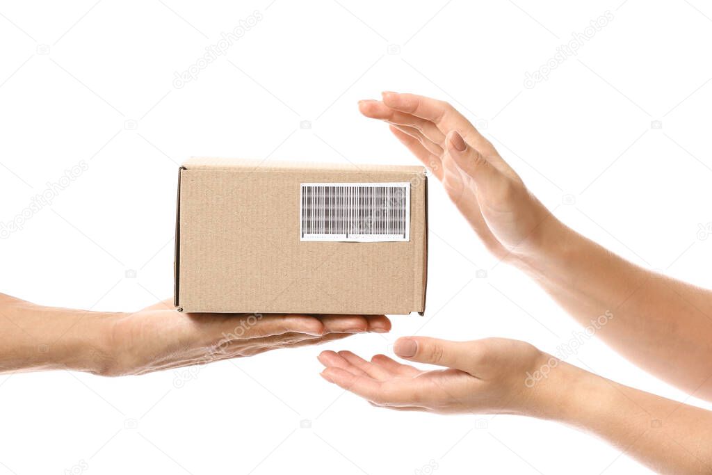 Courier giving parcel to customer on white background, view of hands