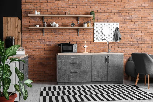 Interior Modern Kitchen Counters Hanging Pegboard Brick Wall — Stock Photo, Image