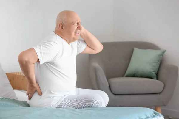Senior Man Suffering Back Pain Bed Home — стоковое фото