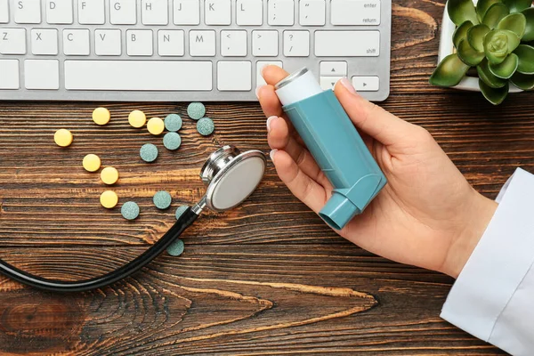 Female Doctor Holding Asthma Inhaler Keyboard Pills Stethoscope Wooden Background — 스톡 사진