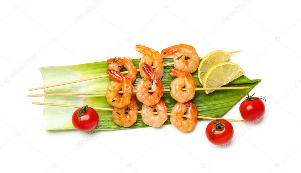 Grilled shrimp skewers with lemon and tomatoes on white background
