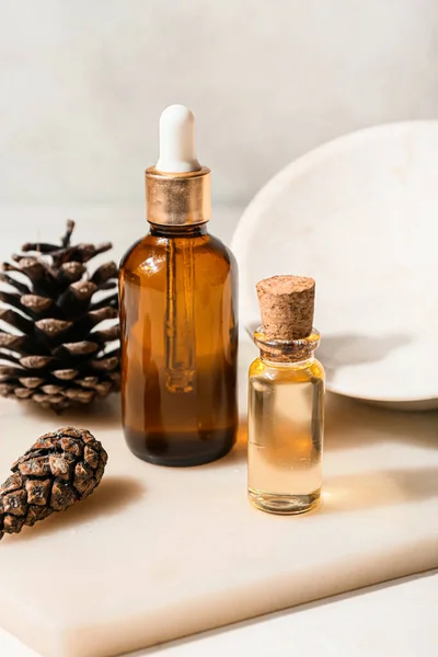 Board Bottles Essential Oil Pine Cones Light Background Closeup — 图库照片