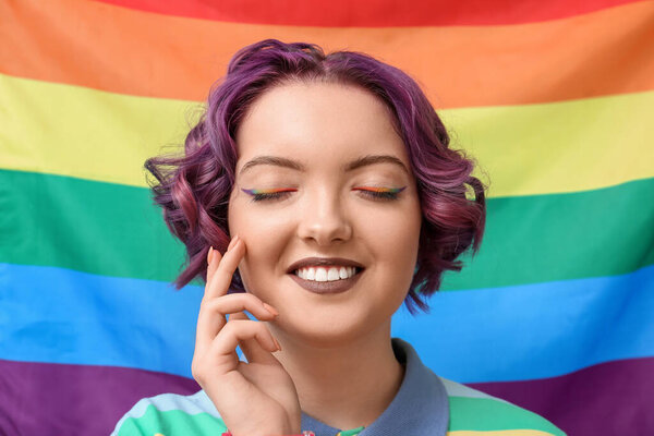 Young woman against LGBT flag