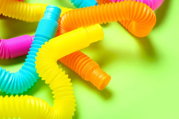 Different Pop Tubes Green Background Closeup — Stock Photo, Image
