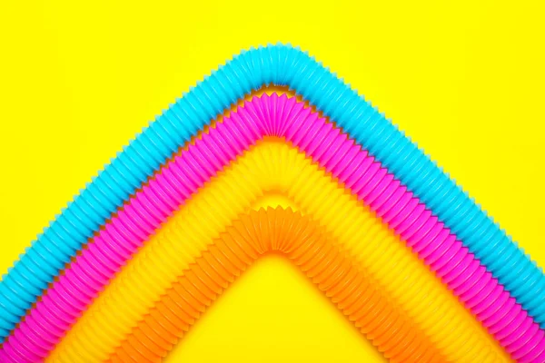 Pop Tubes Yellow Background — Stock Photo, Image