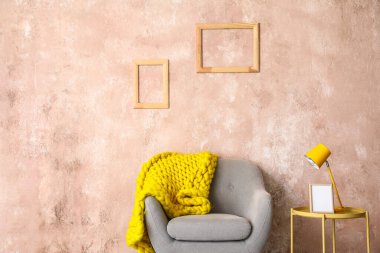 Lambalı, çerçeveli ve renkli duvarların yanındaki rahat koltuklu şık kahve masası.