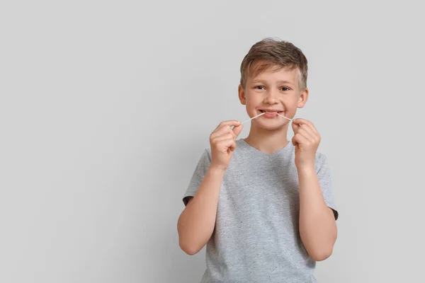 Little Boy Grey Shirt Chewing Gum Light Background — Stockfoto