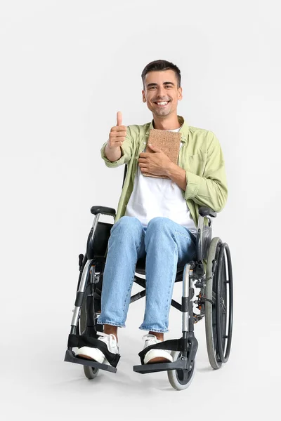 Young Man Wheelchair Book Showing Thumb Light Background — Stock Photo, Image