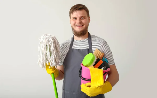 Young Man Cleaning Supplies Light Wall — Zdjęcie stockowe