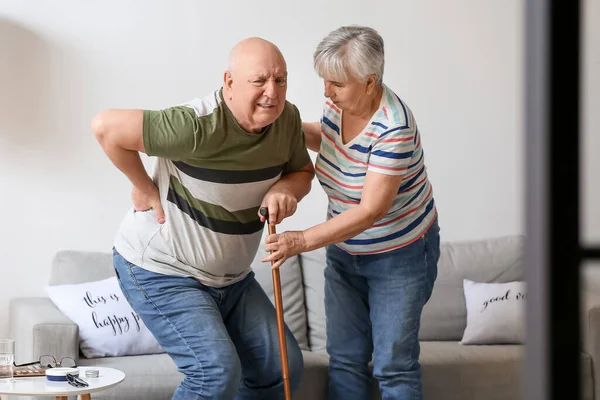 Senior Woman Her Husband Walking Stick Suffering Back Pain Home — 스톡 사진