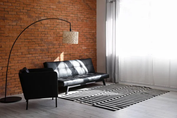 Black Sofa Armchair Lamp Brick Wall — стоковое фото