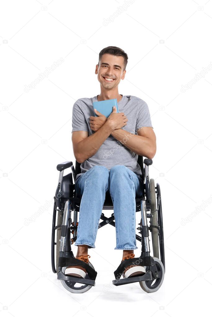 Young man in wheelchair and with book on white background