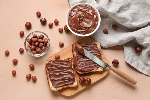 Wooden Board Bread Chocolate Paste Hazelnuts Beige Background — Stock Photo, Image