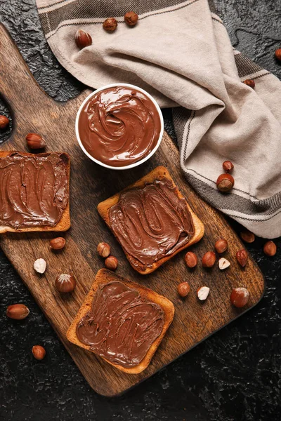 Wooden Board Bread Chocolate Paste Hazelnuts Black Background — Stock Photo, Image