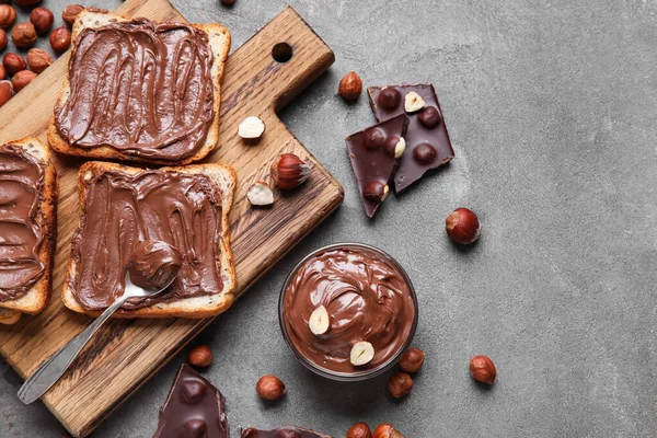 Wooden Board Bread Chocolate Paste Hazelnuts Grey Background — Stock Photo, Image