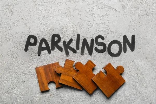 Word Parkinson Met Puzzelstukjes Grunge Achtergrond — Stockfoto