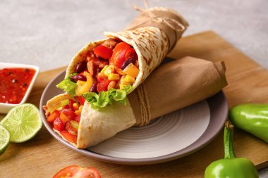 Lezzetli burrito ve soslu yemek masası, yakın plan.