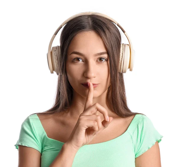 Cool Young Woman Listening Music Showing Silence Gesture White Background — стоковое фото