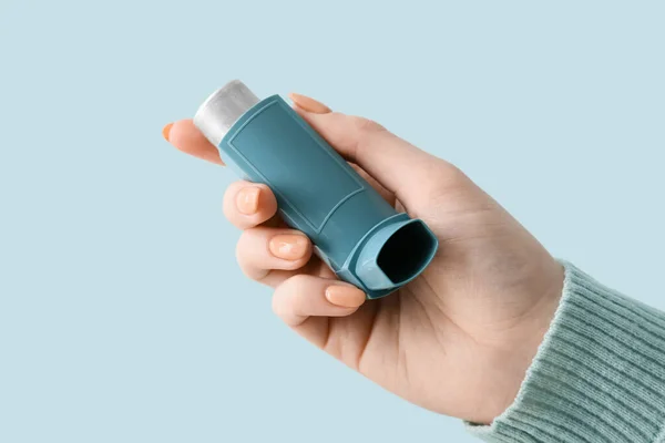 Woman Holding Asthma Inhaler Blue Background Closeup — Stock Photo, Image